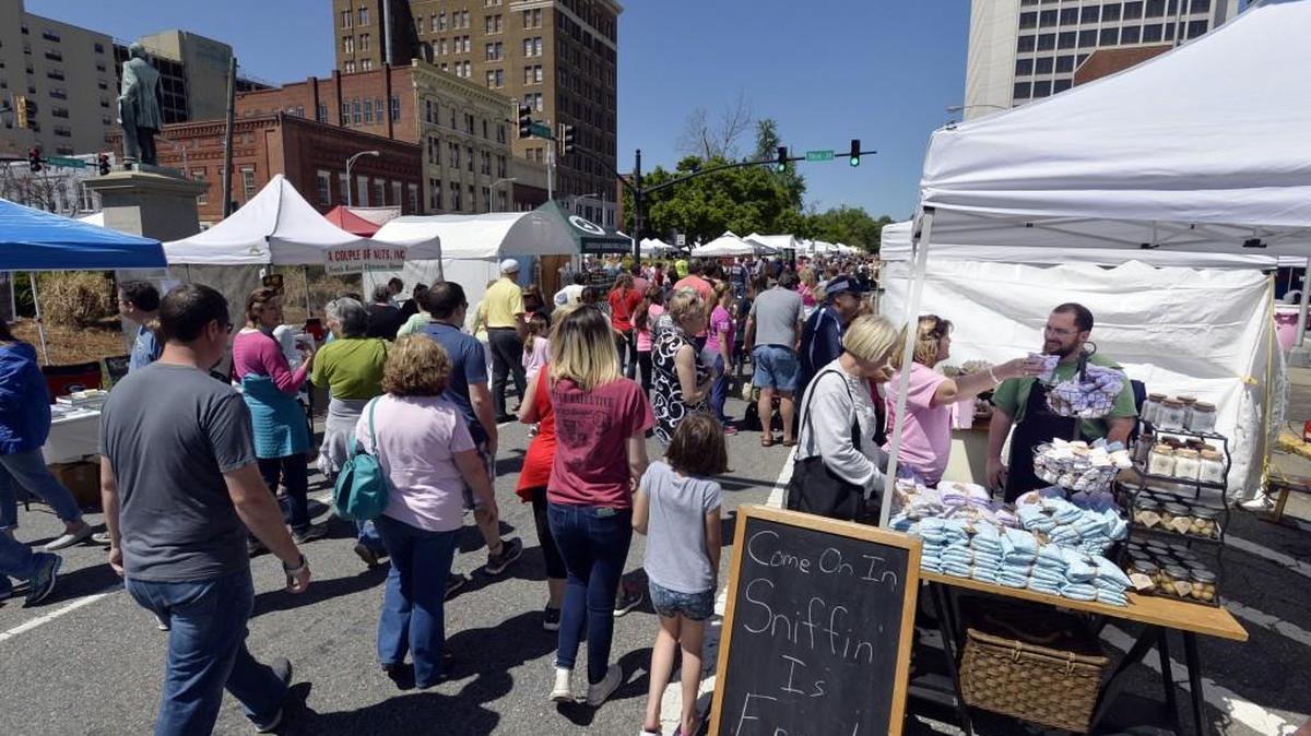 BEAU CABELL/THE TELEGRAPH Macon, Ga., 04/02/2016: Wayne Parker, right, sells his sweet smelling stuff at the corner of Third and Mulberry streets, where the Mulberry Street Arts and Crafts Festival drew big crowds in 2016.