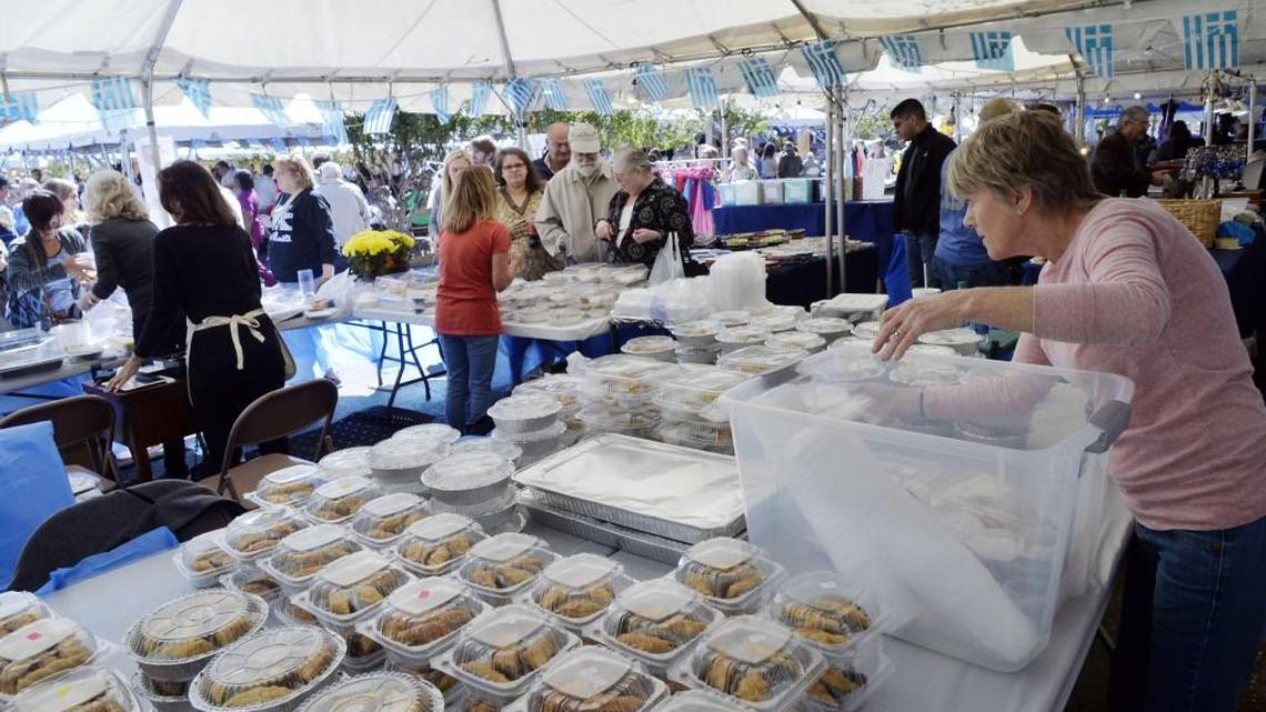 Gina Griggs, right, serves up homemade Greek pastries for the Central Georgia Greek Festival crowd Oct. 22, 2016, at Holy Cross Greek Orthodox Church in Macon.