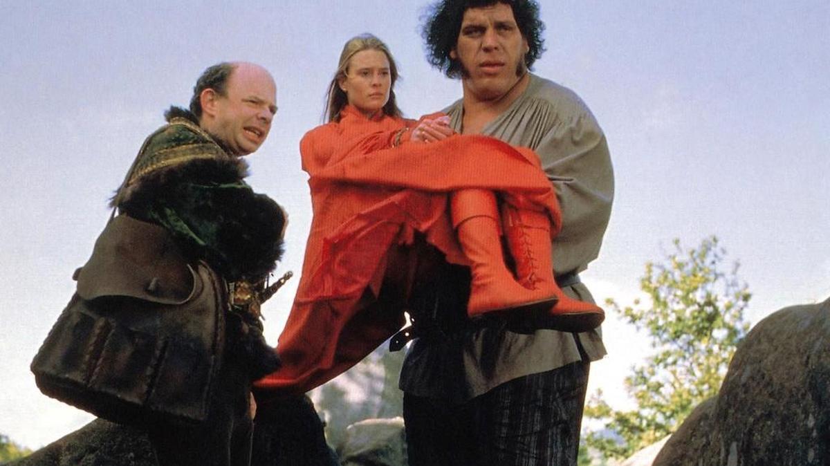 Buttercup (Robin Wright) is held by Fezzick (Andre the Giant) as Vizzini (Wallace Shawn) tries to keep his plan from falling apart in “The Princess Bride.”