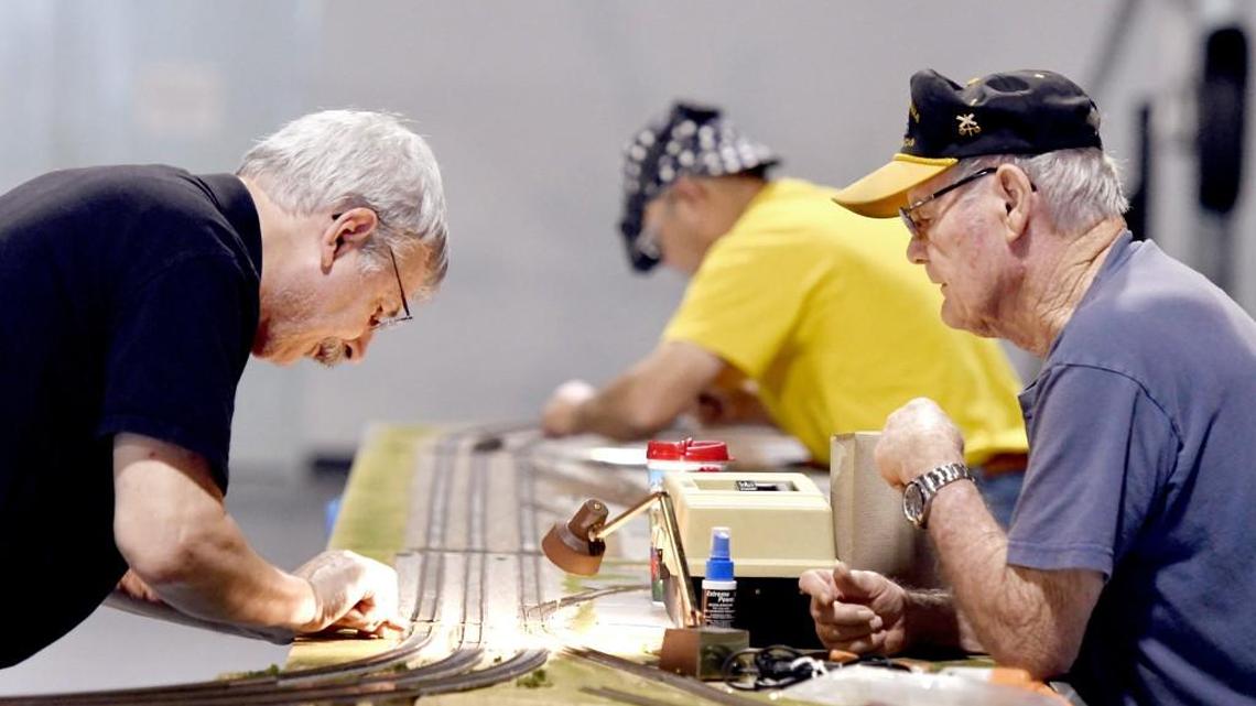 Paul Hutcheson, left and Ron Hinto connect HO scale train modules inside the Century of Flight Hanger at the Museum of Aviation while preparing for “Planes and Trains,” hosted by the Middle Georgia Model Railroad Club. The free exhibit is being through Nov. 26.