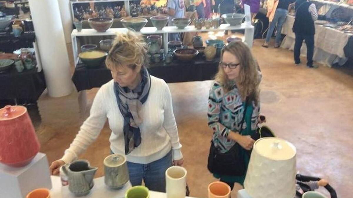 Terrie Hertweck, of Albuquerque, New Mexico, and her daughter Kara Garrett browse the collection of more than 6,000 pieces of pottery at a previous year’s Fired Works event.