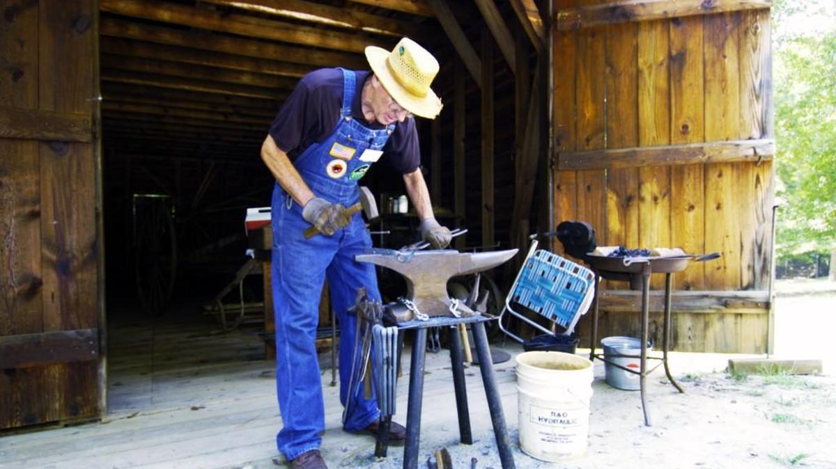Louis Salmon demonstrates how blacksmiths worked at Jarrell Plantation.