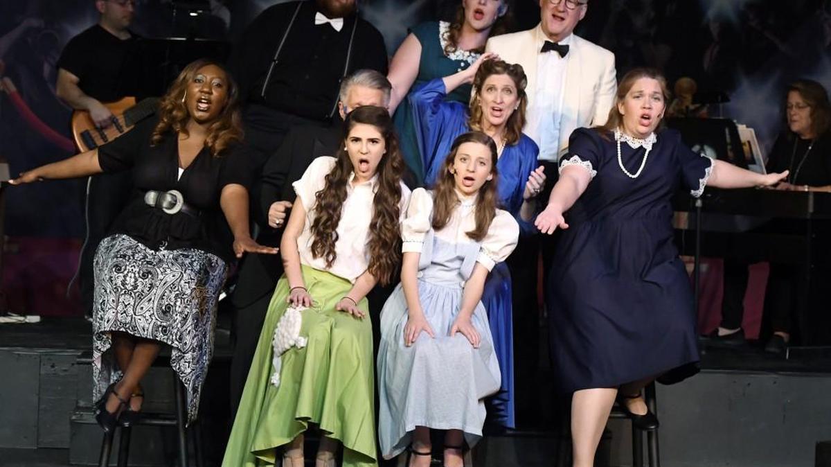 The cast of Macon Little Theatre’s production of “Blame it on the Movies” musical revue rehearses a song Monday night. The show opens Friday.