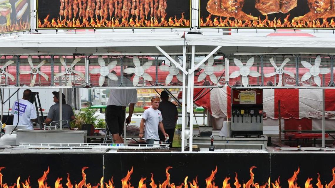 Workmen assemble Gabby’s Famous Kitchens along the midway of the 2014 Georgia National Fair.
