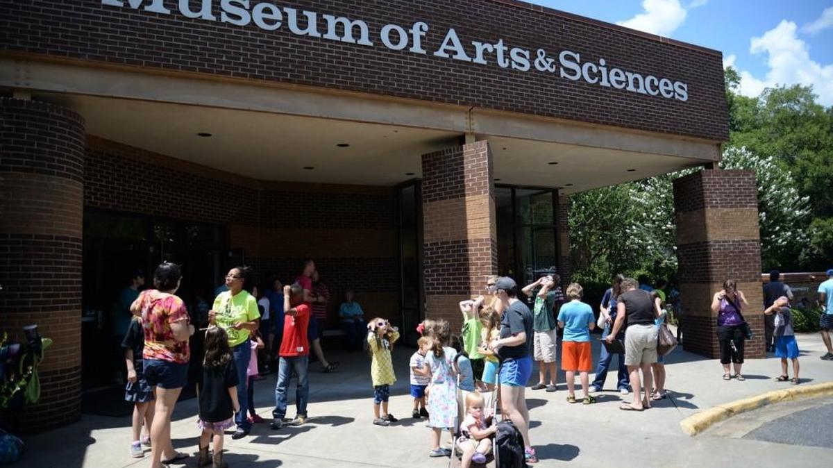 People gather in front of the Museum of Arts & Sciences in Macon to view the solar eclipse on Aug. 21, 2017.