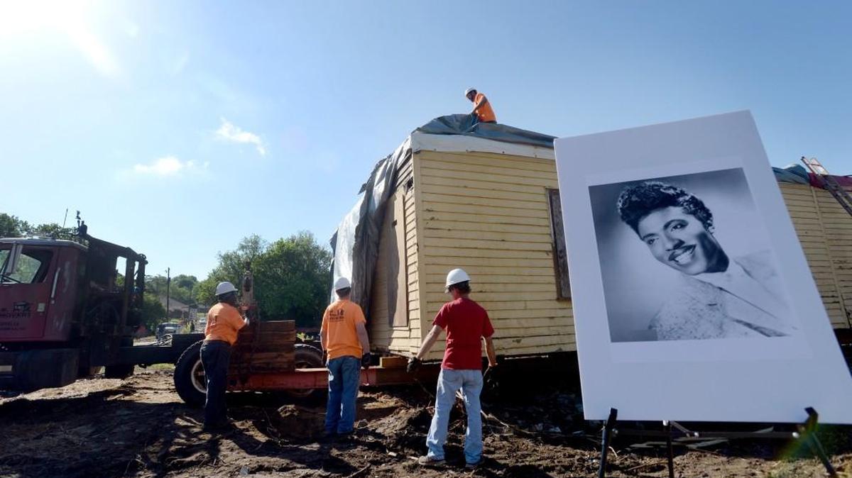 A moving crew removes a tarp from atop Little Richard’s childhood home on Fifth Avenue on April 25. The house was moved to 416 Craft St., where it will be turned into a community center for the Pleasant Hill neighborhood.