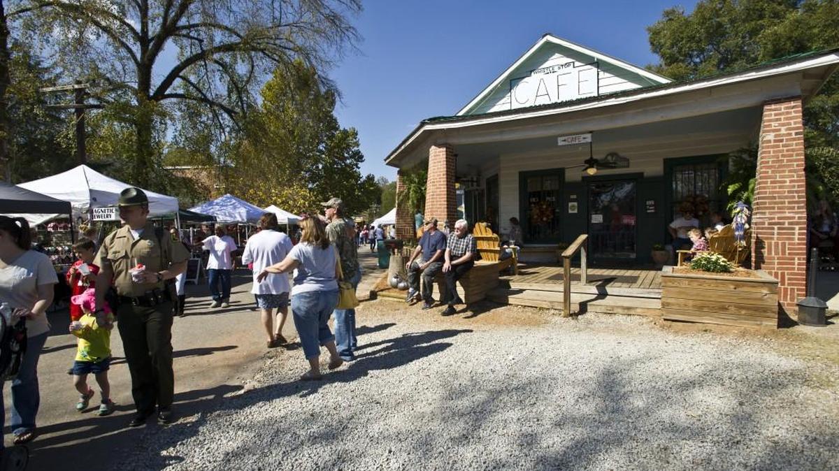 People wander the street at the Whistle Stop Cafe at the 2016 Green Tomato Festival in Juliette.