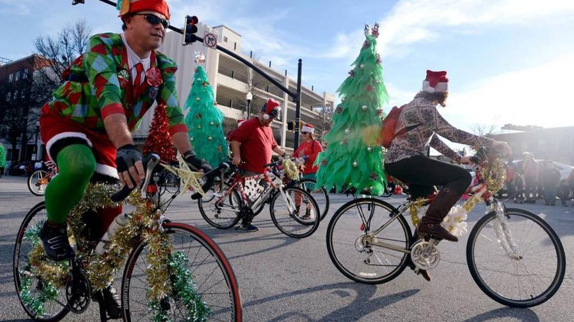 Cyclists bike down Cherry Street during last year’s Main Street Macon Christmas Parade.