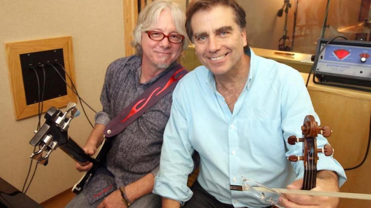 Childhood friends Mike Mills and Robert McDuffie collaborated on “Concerto for Violin, Rock Band and String Orchestra,” which will be released Oct. 14.