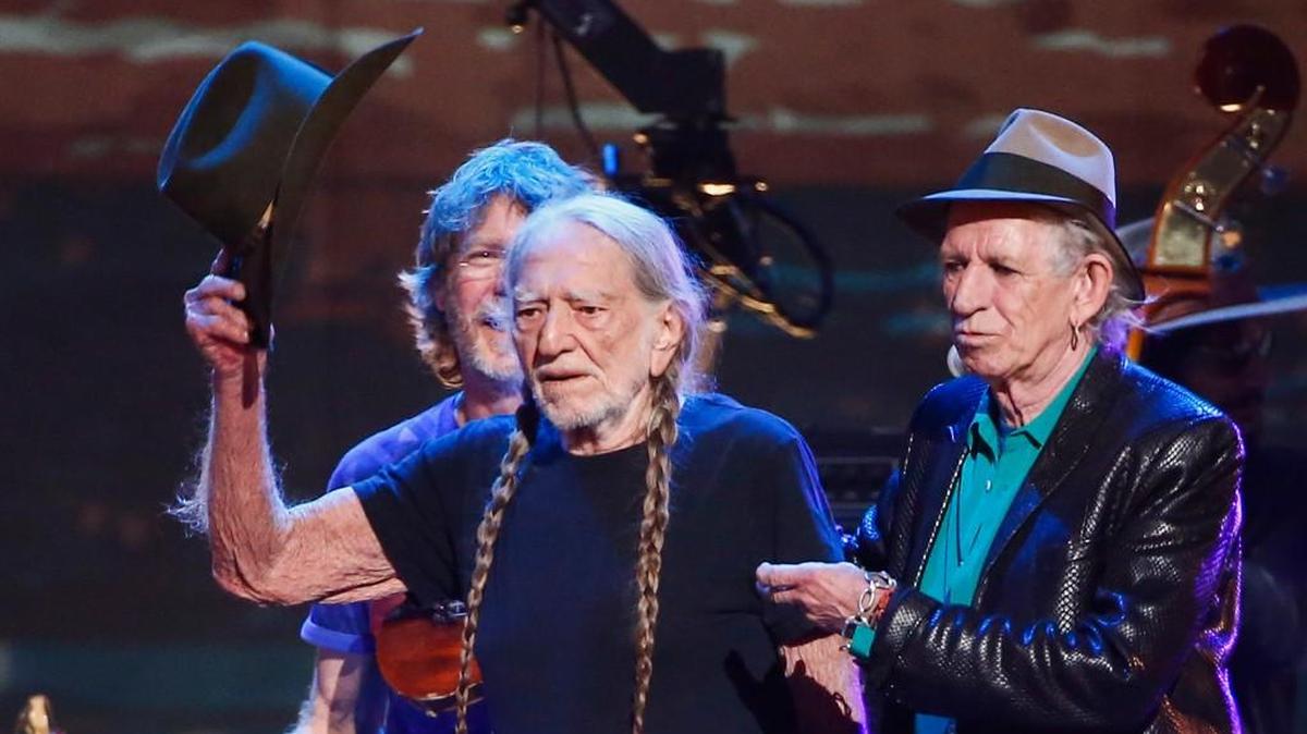 Willie Nelson, left, and Keith Richards perform at the concert “Sing me Back Home: The Music of Merle Haggard” at the Bridgestone Arena on April 6 in Nashville, Tenn.