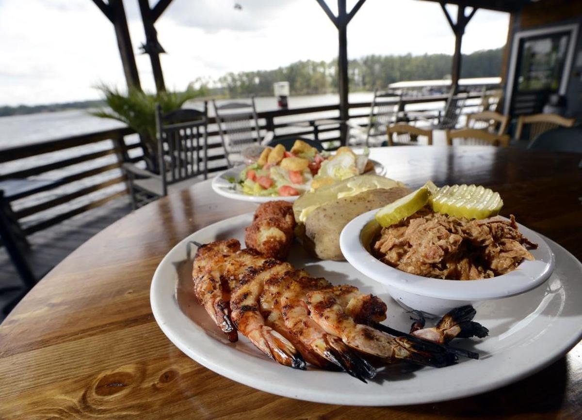 Grilled shrimp and barbecue pork with baked potato and salad at Fish ‘n’ Pig.