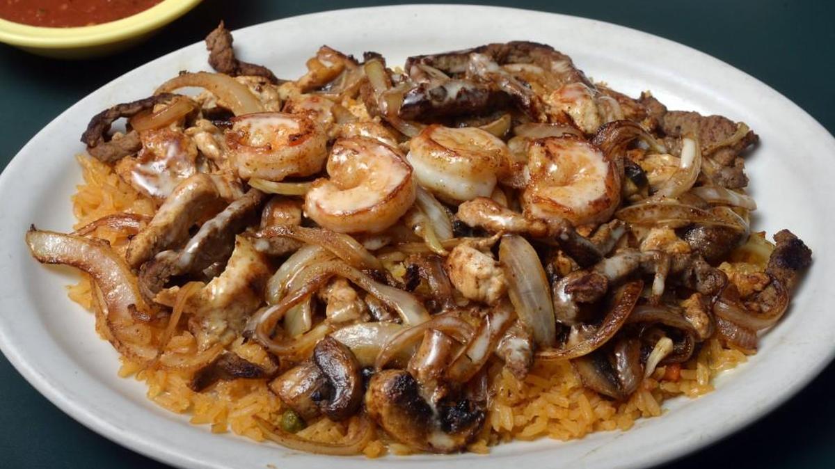 At El Cotija in Warner Robins, the Texas House Special comes with beef and shrimp on a bed of rice with cheese, onions and mushrooms.