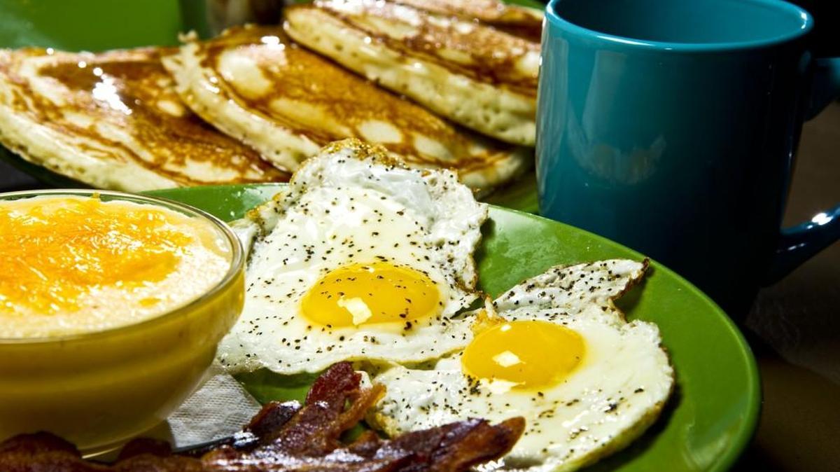 Among the breakfast menu offerings at Between the Bread are pancakes, eggs, bacon and grits.