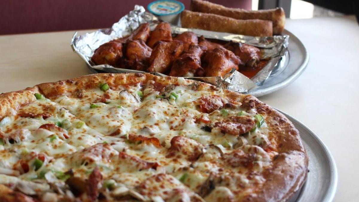 A deluxe pizza and hot wings are among the choice at Stoner’s Pizza Joint on Forsyth Road.