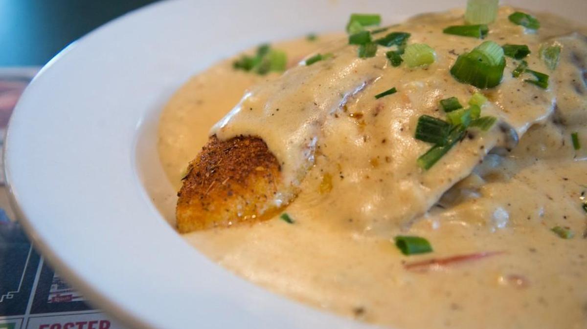 The Cajun Big Fish at Metro Diner is a blackened swai filet served over mashed potatoes with a mushroom cream sauce and green onions on top.