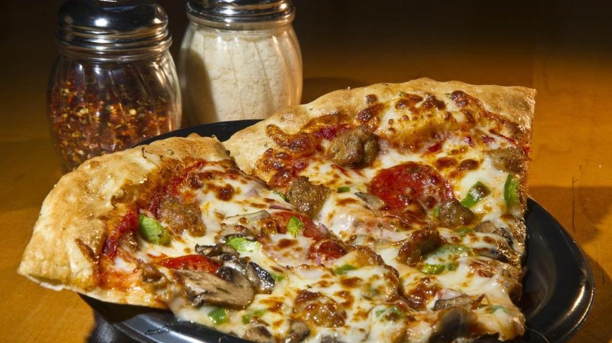 Two slices of supreme pizza sits at Fatty’s Pizza in Macon, Ga.