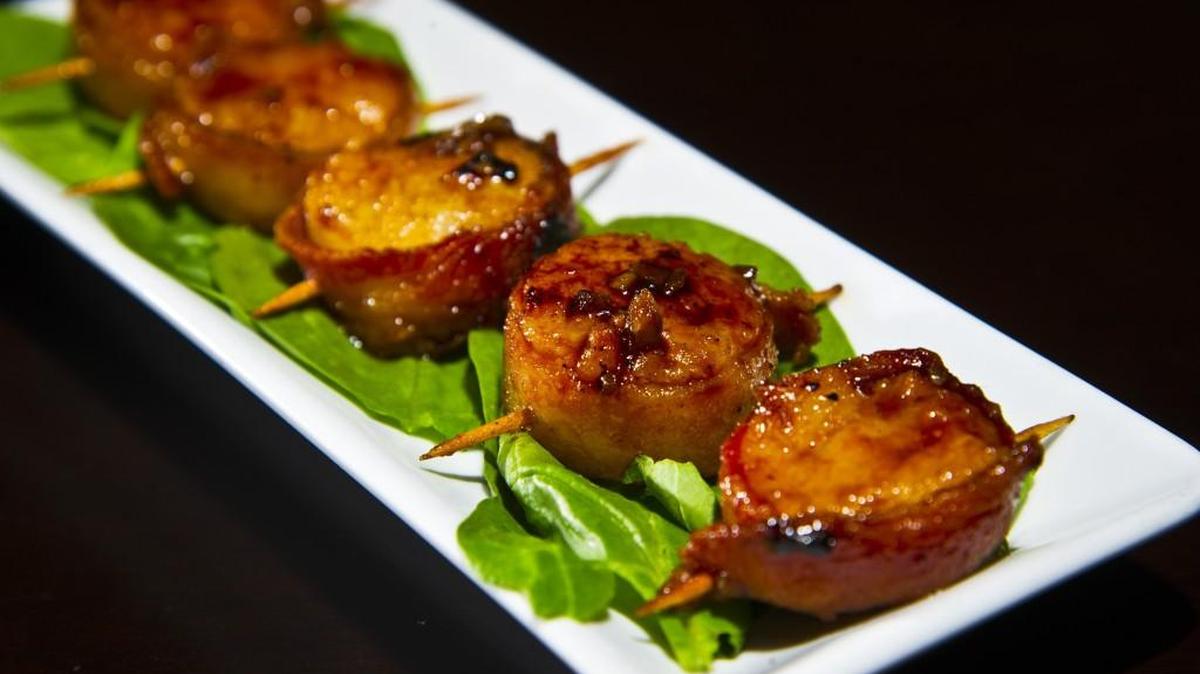 Bourbon glazed scallops are one of the appetizers at SurReal Grill in Gray.