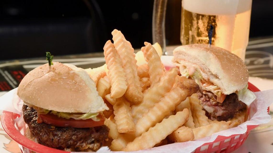 A burger stuffed with blue cheese comes with french fries at Northside Cheers.