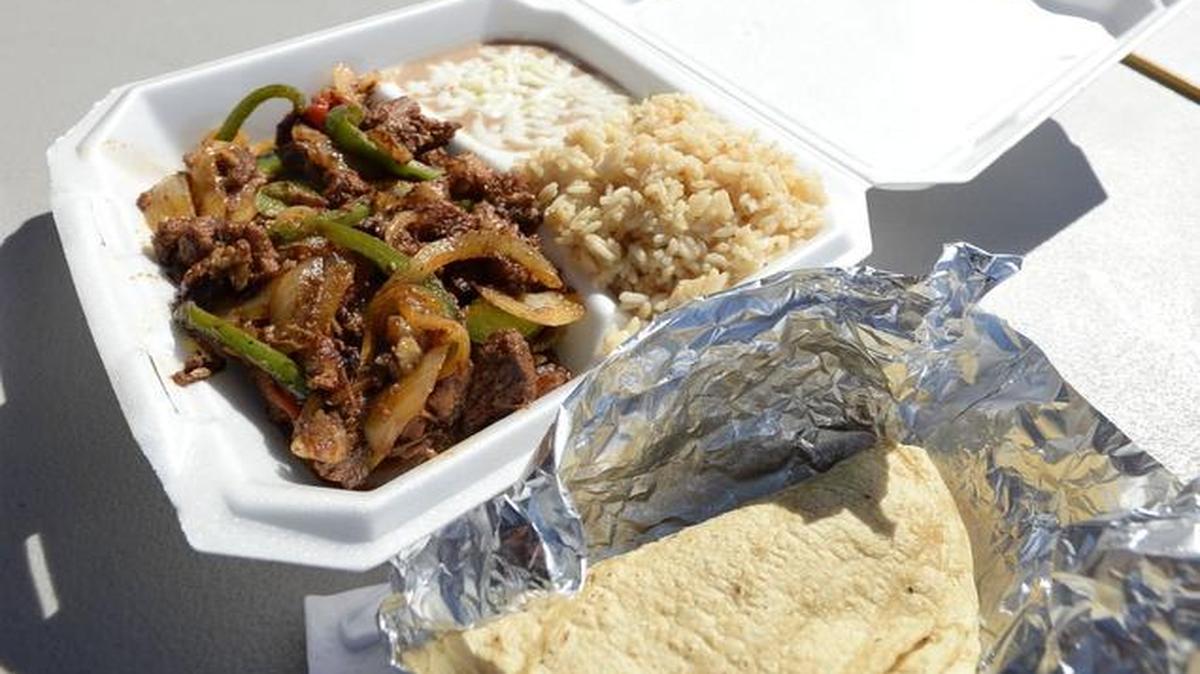 At La Delicia Grill, try the combination pork with green peppers and onions, beans and cheese, rice and tortillas.