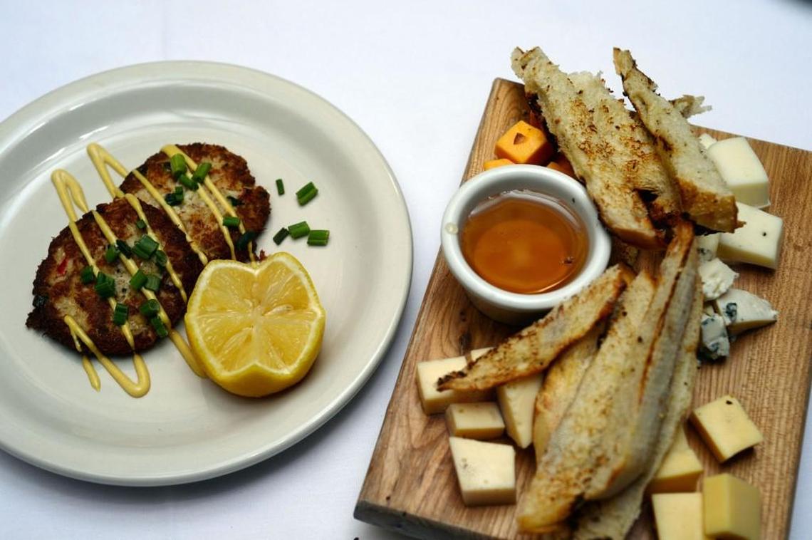 Crab cakes and a cheese board with five different cheeses and bread strips and honey are among the choices at the Downtown Grill.