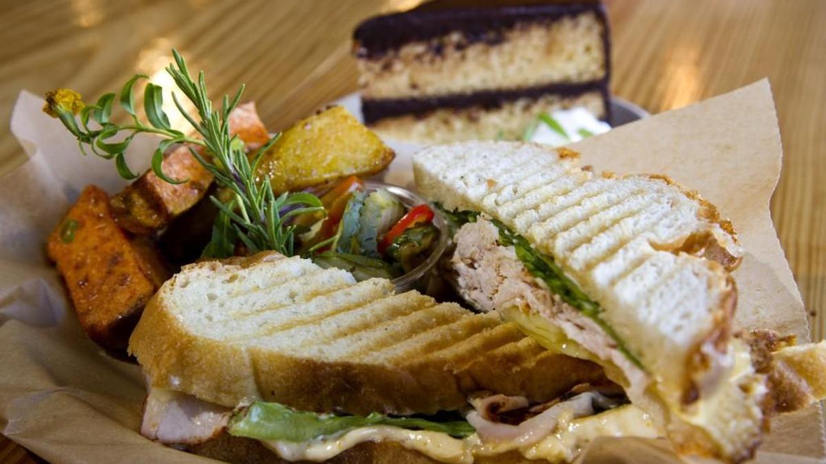 Try the Big Green Egg smoked pork loin sandwich with roasted organic sweet potatoes at Bluetick Mercantile in Forsyth.