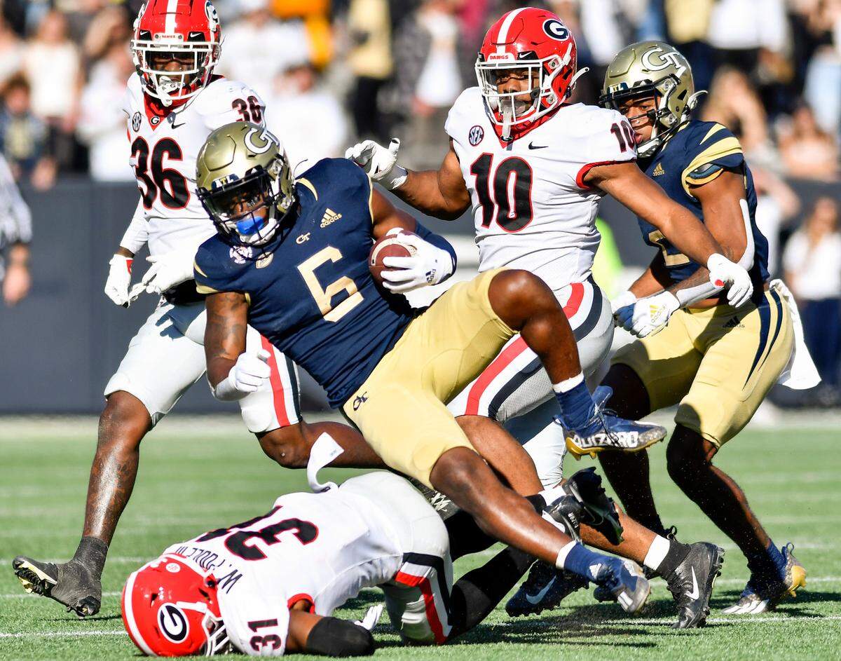 Georgia Tech running back Jamious Griffin (6) is tripped up in the backfield by Georgia defensive back William Poole (31) during the Bulldogs 45-0 win Saturday in Atlanta.