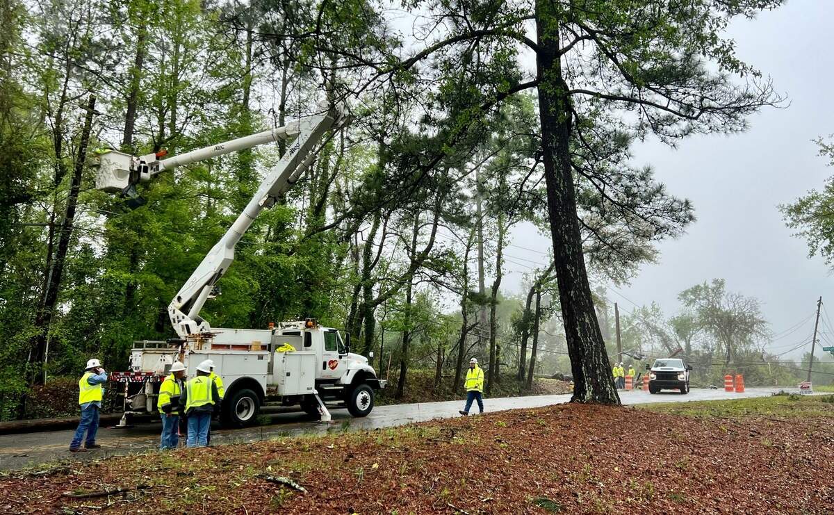 Crews work to restore electricity in North Macon after a severe weather system moved through Georgia Tuesday afternoon, tearing down trees and power lines.