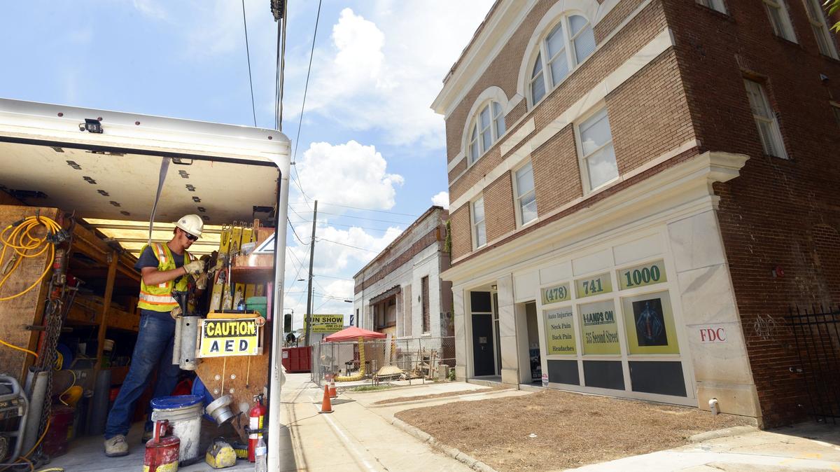 Workmen in front of the old Crescent Building on Second Street are now in the process of taking electrical utilities underground for the entire block — part of a big mixed-use development project.