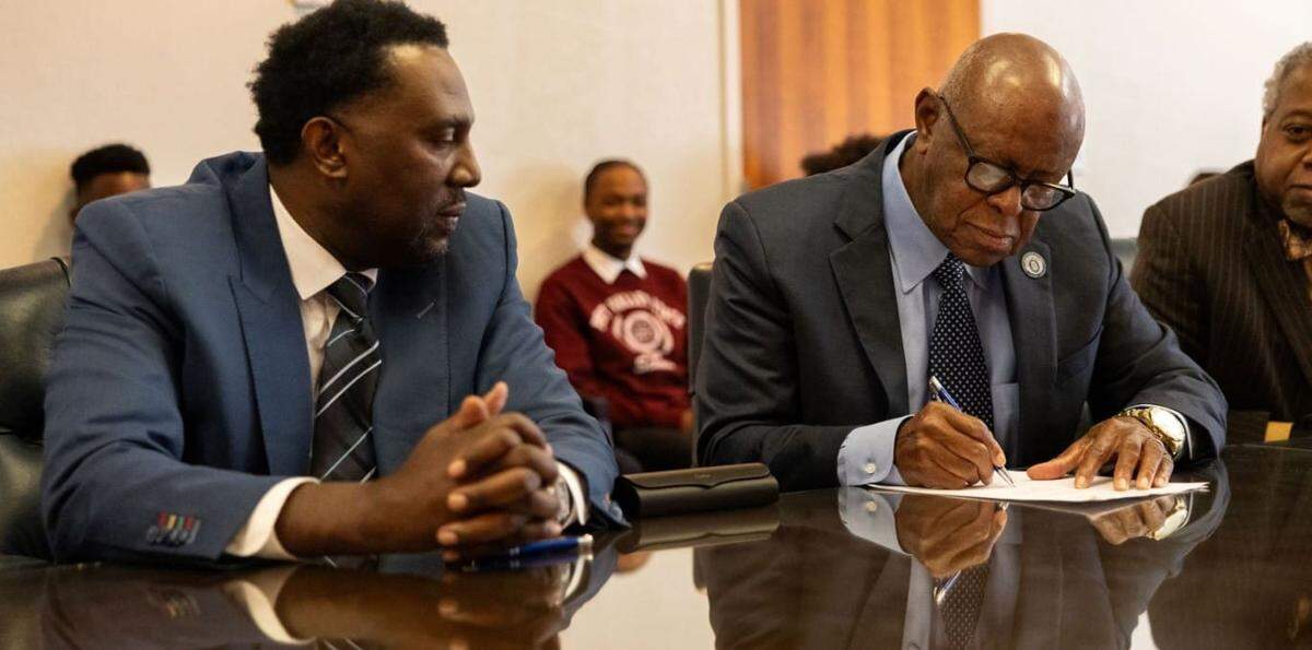 Imola Automotive USA CEO Rodney Henry, left, looked on as Dr. Isaac Crumbly, of Fort Valley State University in Georgia, signed an agreement in 2024 to collaborate on science and workforce development. It was part of Imola’s plan to develop an electric vehicle plant in Fort Valley. Since then, however, there has been no sign of construction.