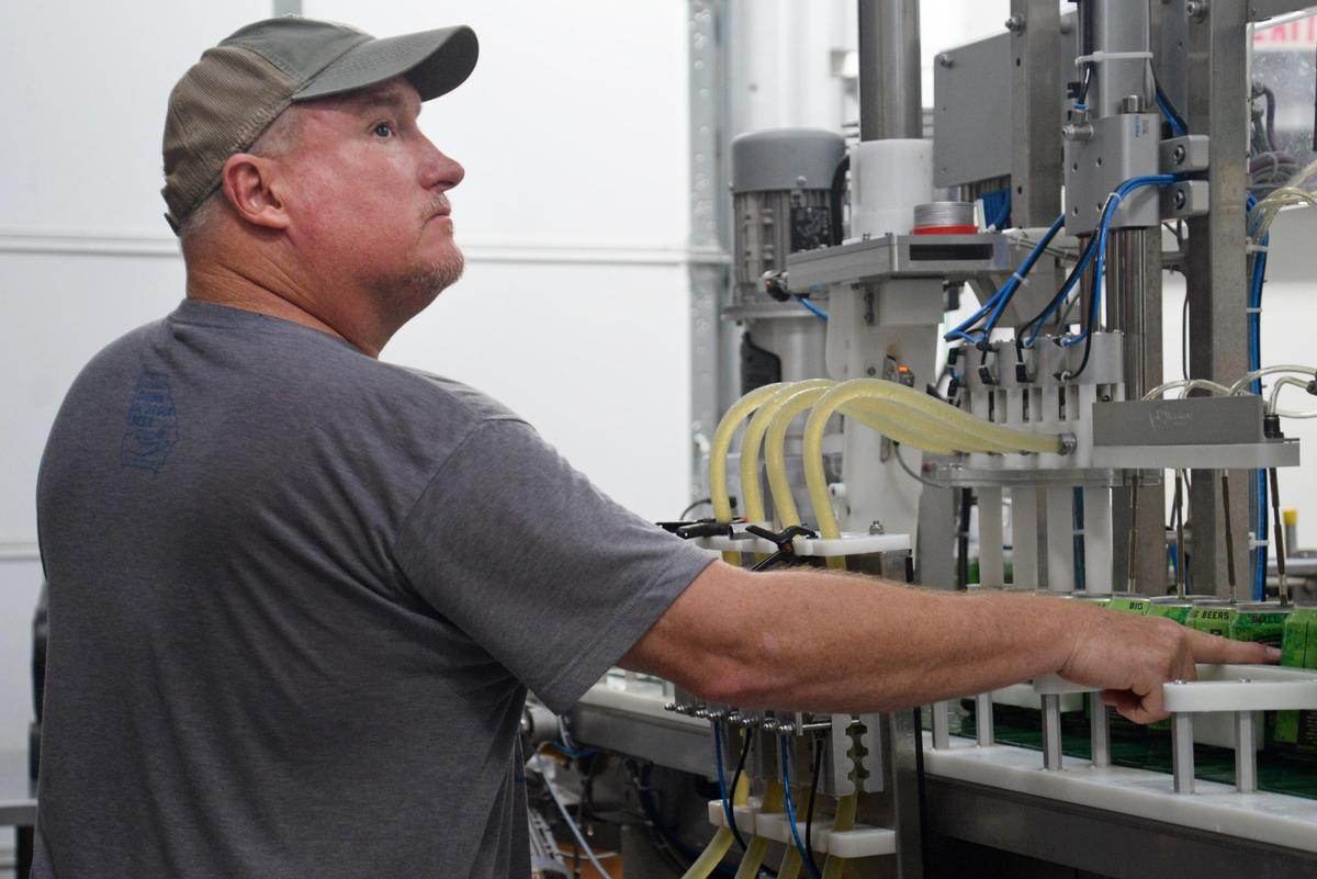 Dee Moore, the brewmaster at Omaha Brewing Co., watches the line Wednesday as he and his team can a beer called Hannahatchee Creek India Pale Ale, also known as an IPA. The brewery offers free tours and has a tasting room.
