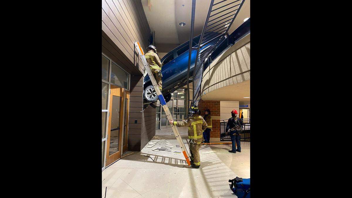A woman was rescued after an SUV went off a parking deck, Georgia firefighters say.