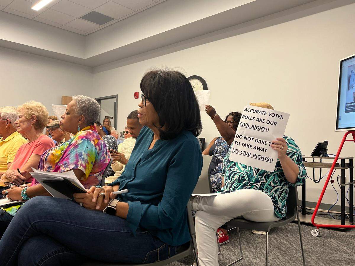 A voter held up a sign that read, “Accurate voter rolls are our civil right!! Do not dare to take away my civil rights!!” at the Macon-Bibb County Board of Elections meeting Monday, July 1, 2024.