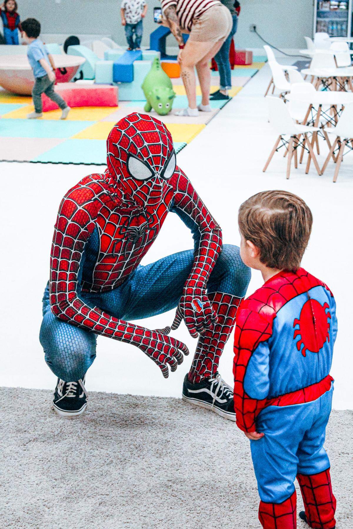 A Dream A Little Wish Entertainment Spiderman performer chats with a little boy while visiting Peachy Playtown in Perry.