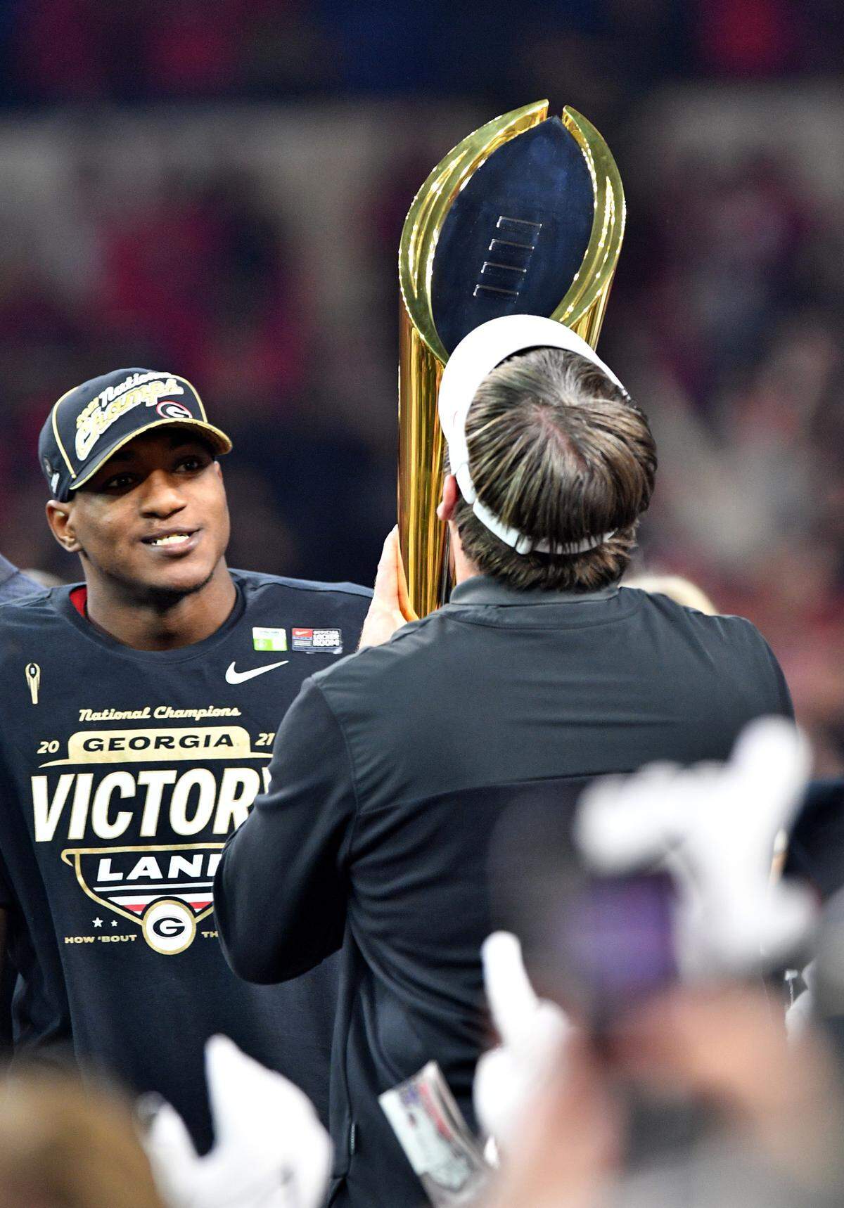 Georgia head coach Kirby Smart kisses the championship trophy after the Bulldogs’ 33-18 win over Alabama in the College Football Playoff National Championship game Monday night.