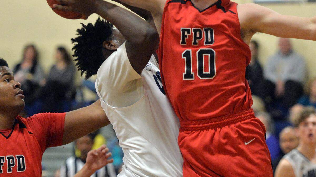 BEAU CABELL/THE TELEGRAPH 
 Macon, Ga., 0 1/26/2016: FPD's Jacob Oates (10) fouls Mt. De Sales' Michael Fountain during first half action.