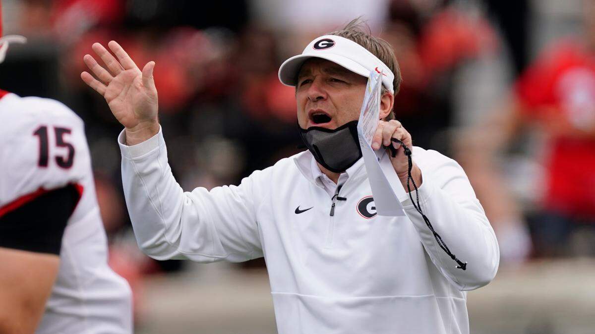 Georgia head coach Kirby Smart talks to his players before Georgia’s spring NCAA college football game, Saturday, April 17, 2021, in Athens, Ga. (AP Photo/John Bazemore)