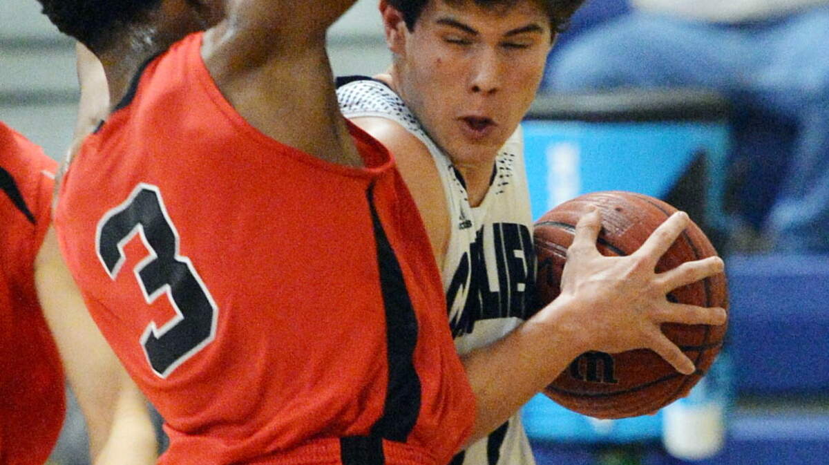 FPD's Armaun Smith (3) blocks a driving Mt. De Sales' guard Henry Middlebrooks (11).