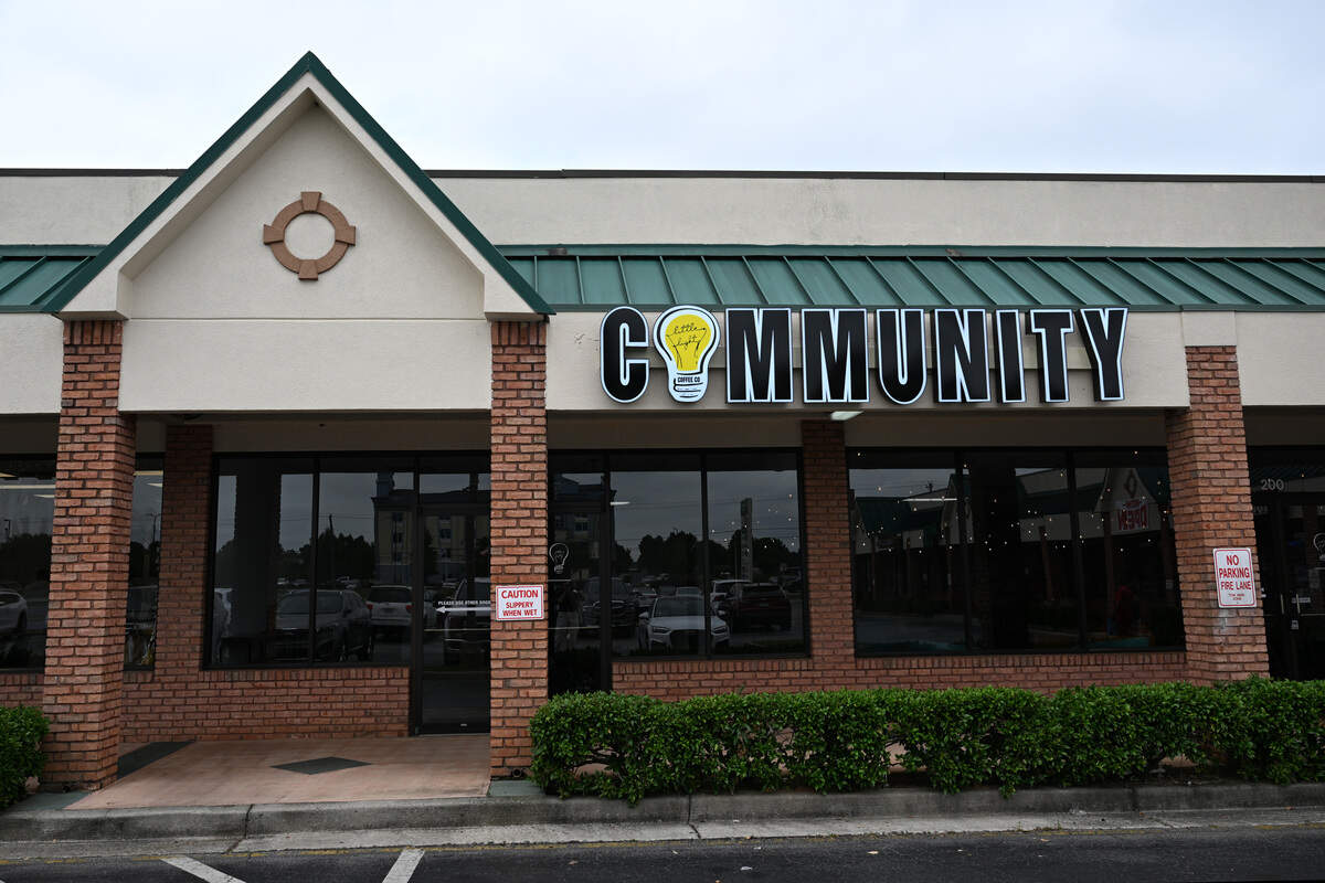 A new “Community” sign hangs outside of the new “third space” of Little Light Coffee Co. on Wednesday, July 30, 2025, in Warner Robins, Georgia. The new space, which officially opened August 1, is connected to the original shop.