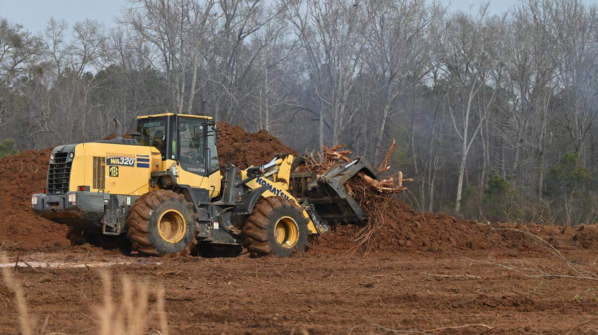 A bulldozer clears land for the new site of a new Kroger Marketplace off Perry Parkway in January 2026.