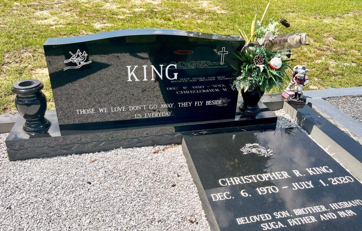 An etching of a largemouth bass graces the tombstone of Chris King’s grave at the Lizella Baptist Church Cemetery west of Macon, Ga.