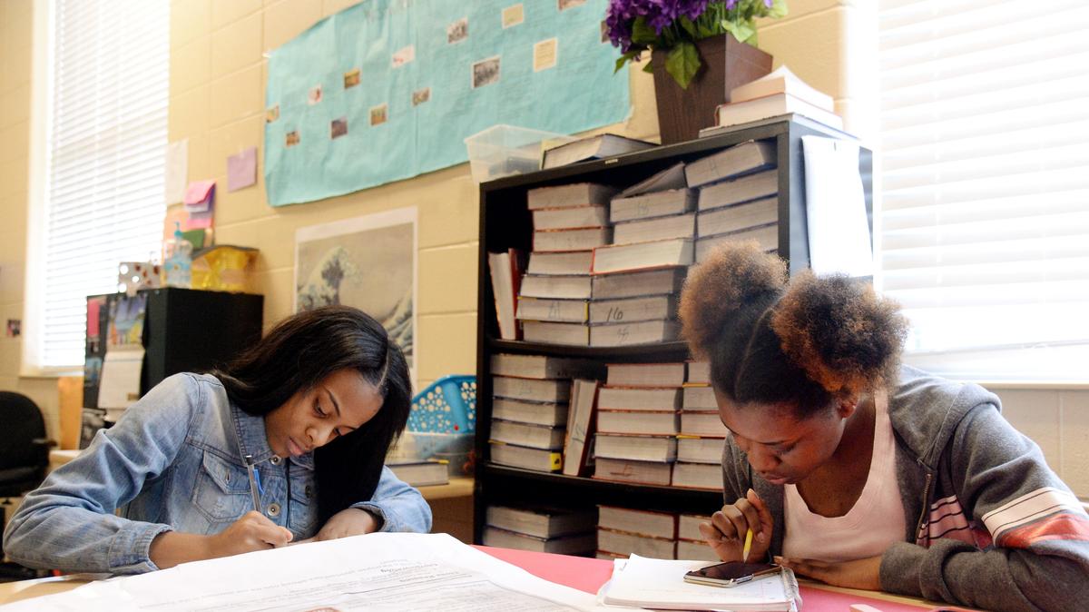 Central students Kaia Raines, left, and Jenaya Brown work on a lesson about the New Deal on Tuesday in Meagan Harris' U.S. History class. Students are allowed to use their personal electronic devices or a school-supplied device to help search for information to complete the assignment.