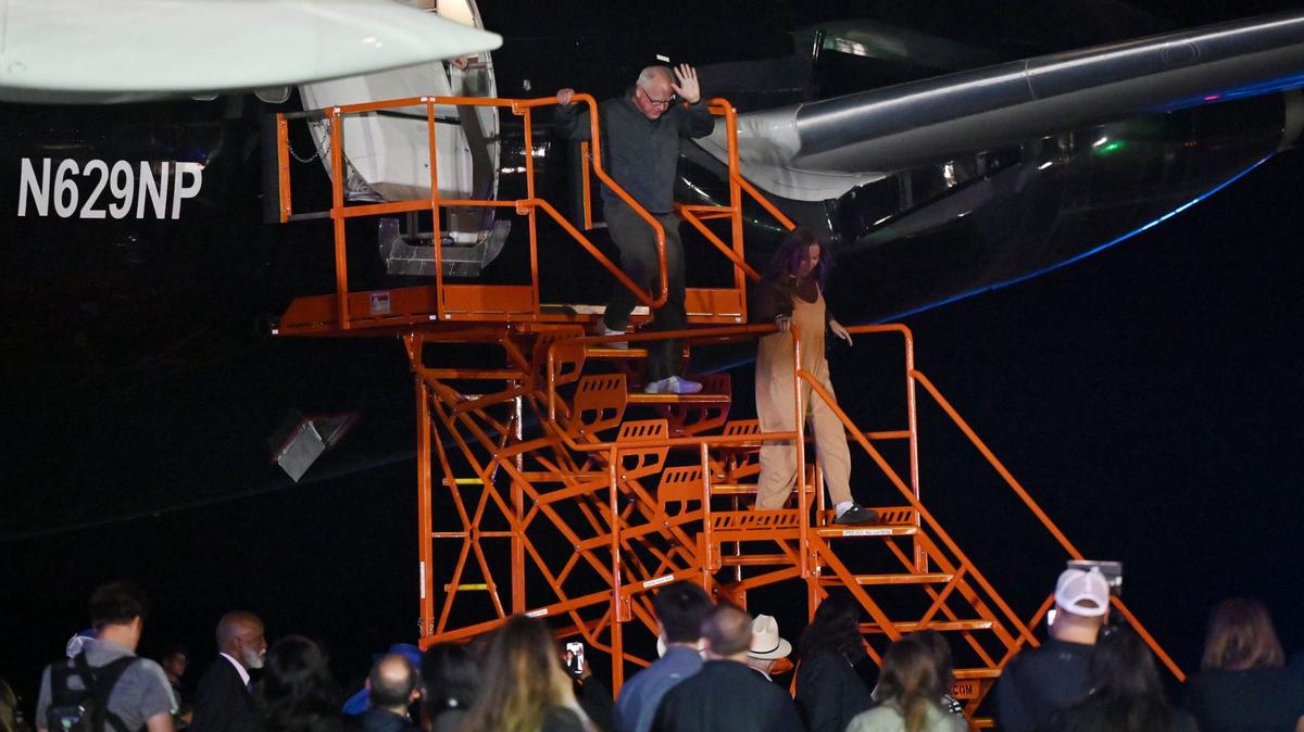 Minnesota Gov. Tim Walz descends the stairs after exiting a plane with his daughter, Hope Walz, at Middle Georgia Regional Airport on Monday, Sept. 16, 2024, in Macon, Georgia. Walz will visit Macon on Tuesday before traveling to Atlanta and Asheville for Harris-Walz campaign events.