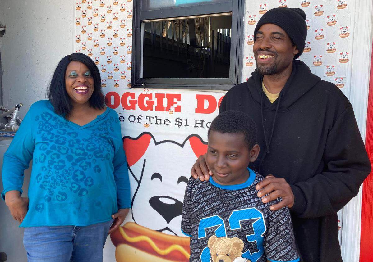 Doggie Dogs owner, Tony Walker, with his mom, Helen Walker Law, and his 8-year-old son, Antonio.