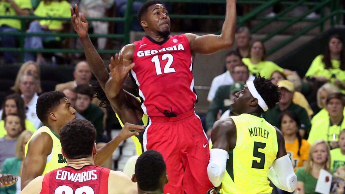 Georgia guard Kenny Gaines (12) scores over Baylor forward Johnathan Motley (5) during the first half of an NCAA college basketball game Saturday, Jan. 30, 2016, in Waco, Texas. Baylor won 83-73. (Rod Aydelotte/Waco Tribune Herald via AP)