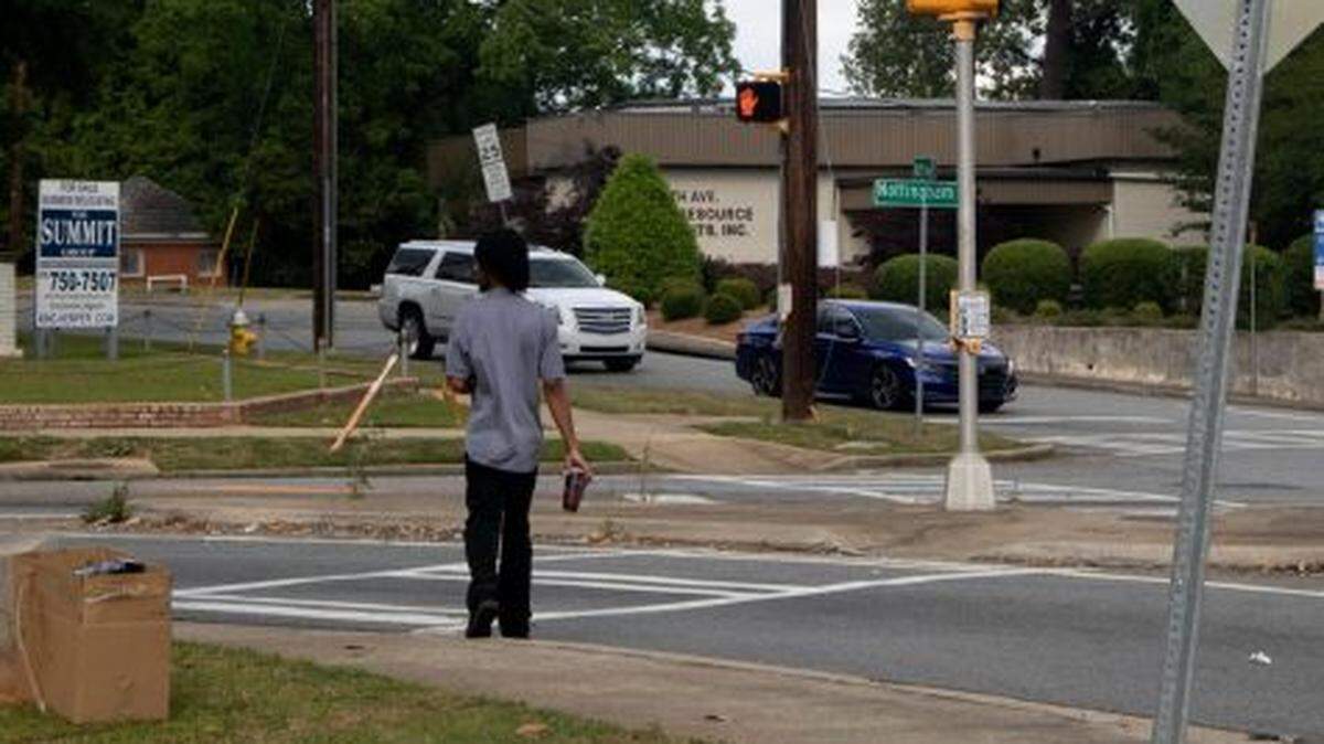 A pedestrian crosses the street in front of the Kroger on Gray Highway in Macon. The county is seeking public input on how to allocate grants for increased pedestrian safety.