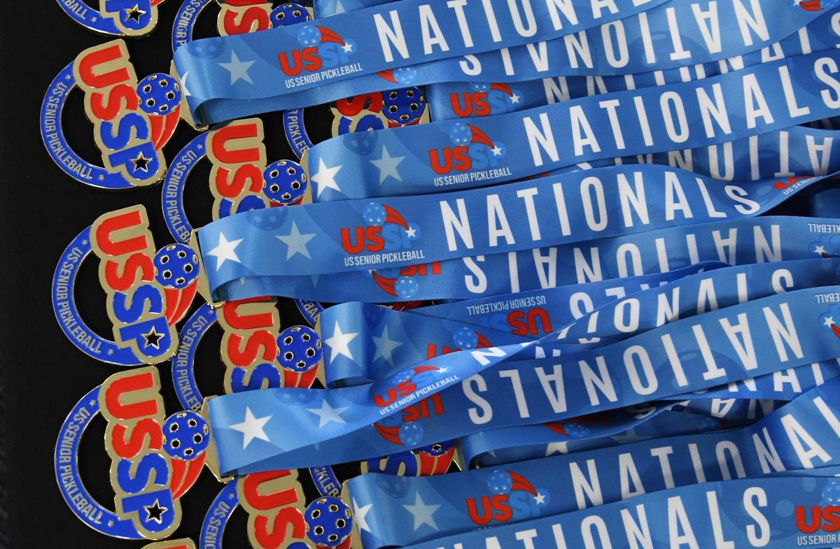 Medals from the United States Senior Pickleball Indoor National Championships rest on a table on Saturday, July 13, 2024, at Rhythm & Rally Sports & Events in Macon, Georgia. United States Senior Pickleball hosted its inaugural indoor national championships this year, spanning three days and bringing hundreds of seniors to compete in Macon from across the country.