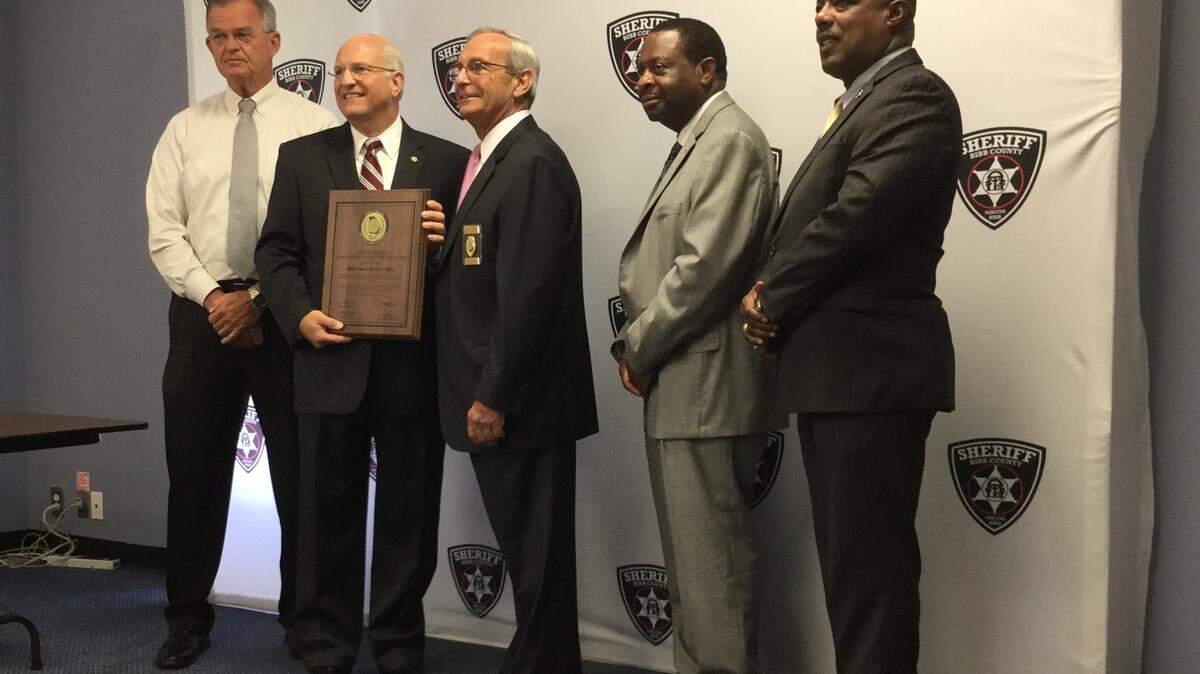 AMY LEIGH WOMACK/THE TELEGRAPH, 08/1 1/2015: 
 Representatives of the Bibb County Sheriff's Office pose with a plaque signifying deputies have achieved certification from the Georgia Association of Chiefs of Police