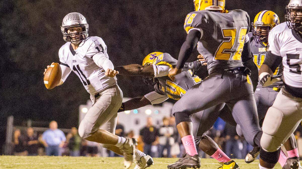 CLAY TEAGUE/FOR THE TELEGRAPH 
 Gray, GA, 10/16/15 
 Houston County's Jake Fromm eludes a sack in the first half of their 2-AAAAA showdown against Houston County/ Jones County.