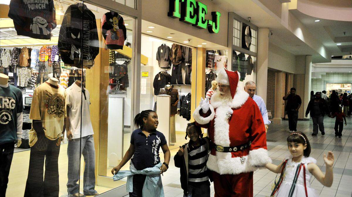 Aya George, left, and Douglas Moore III, second from left, walk with Santa Claus and Christmas Princess Nina Durden through the Macon Mall after Santa's arrival at the mall in 2010. This holiday shopping season authorities offer tips to keep safe -- No. 1 is to be aware of your surroundings at all times.