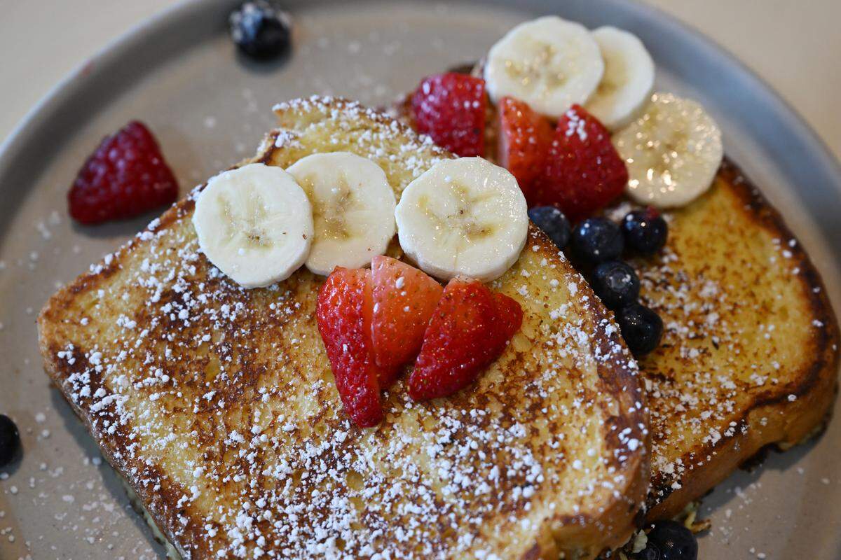 French toast from Meridian Brunch & Bar features brioche bread and is topped with blueberries, strawberries, bananas and powdered sugar.